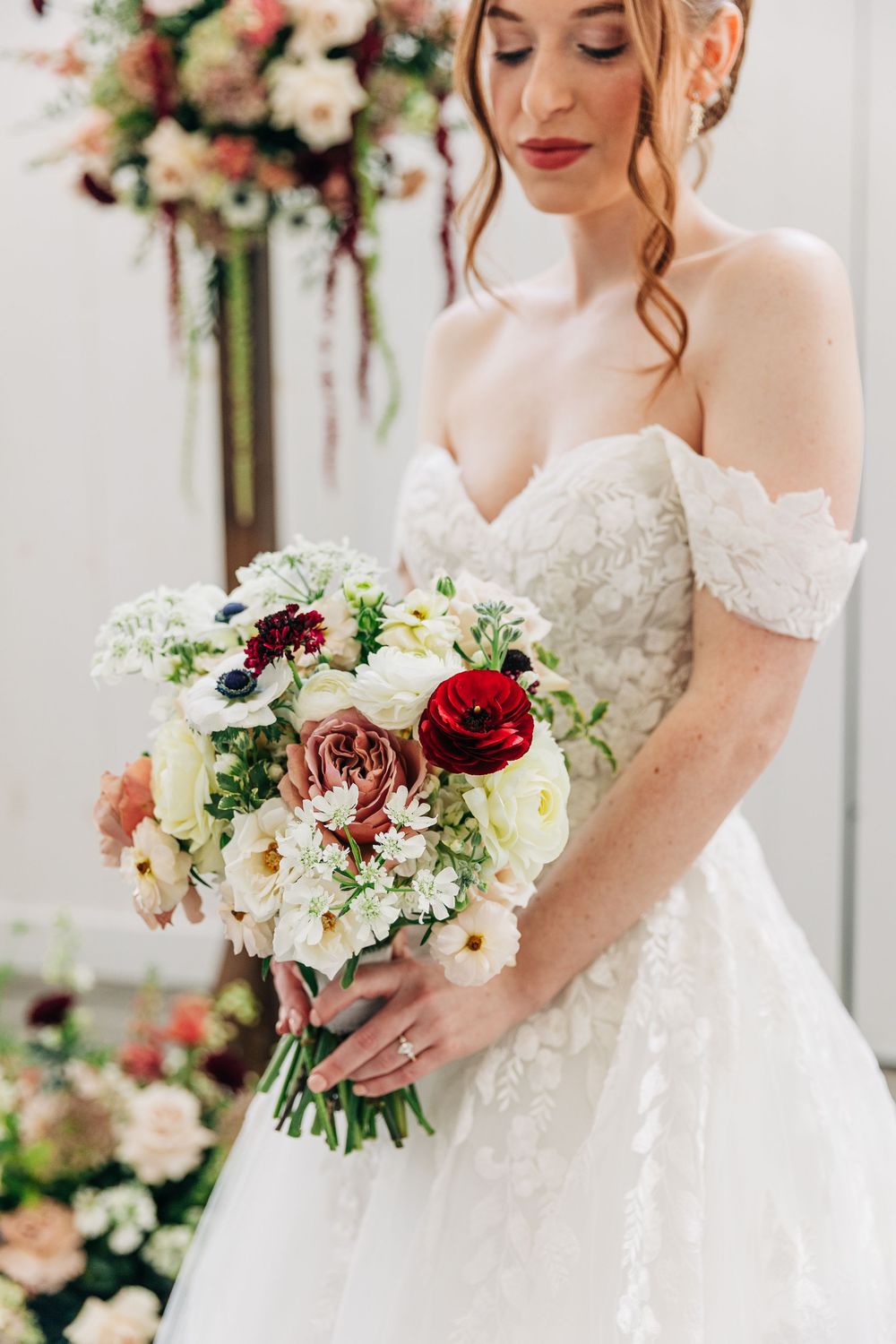 A bridal portrait series showing an elegant off-shoulder wedding dress and romantic floral bouquet in soft lighting.