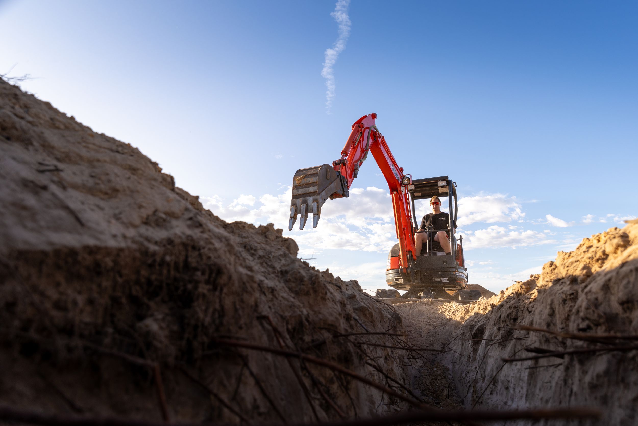 Mini excavator digging trench on site in Murray Bridge