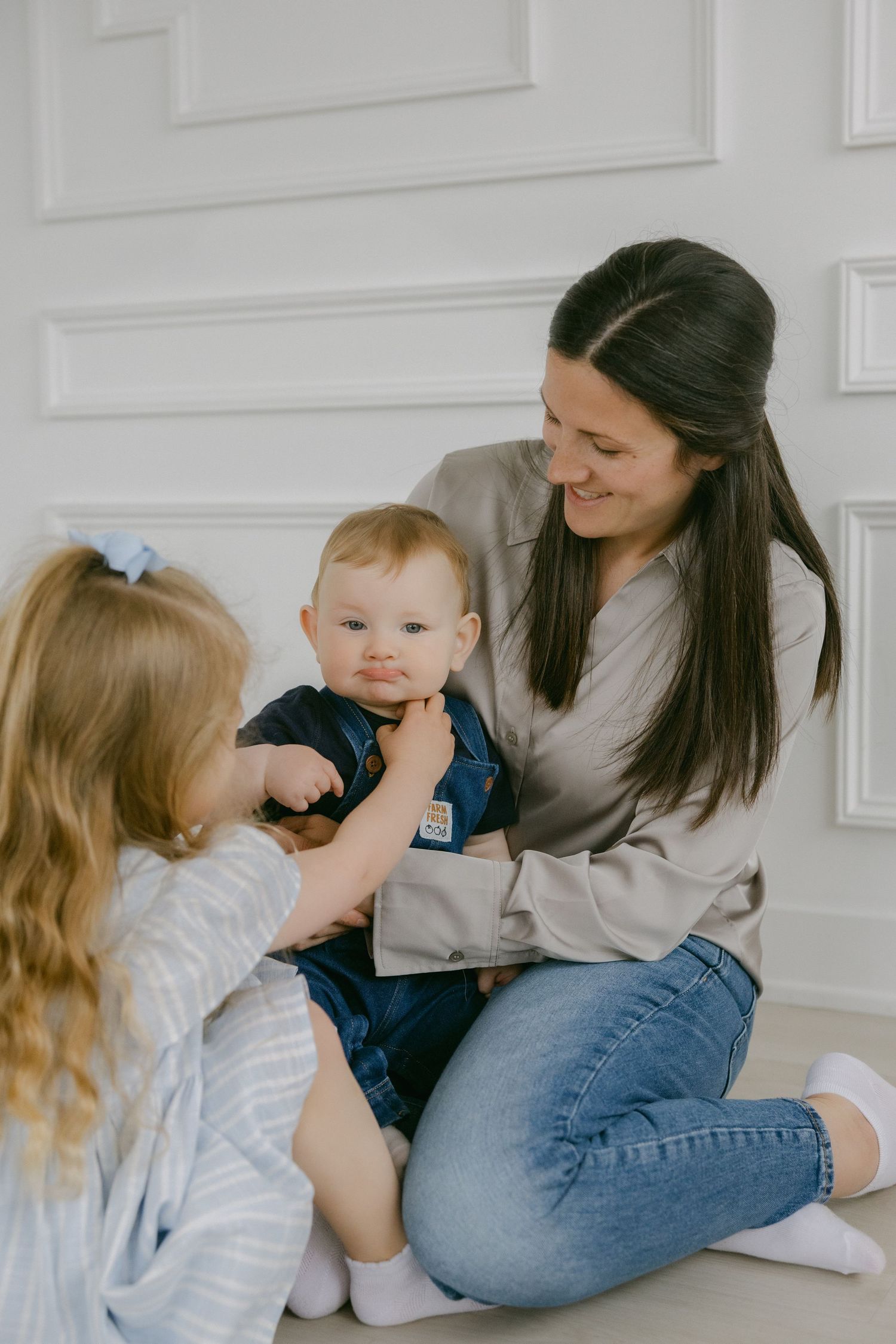 A sweet family moment captured in a series of candid photos showing tender interactions between parent and children.