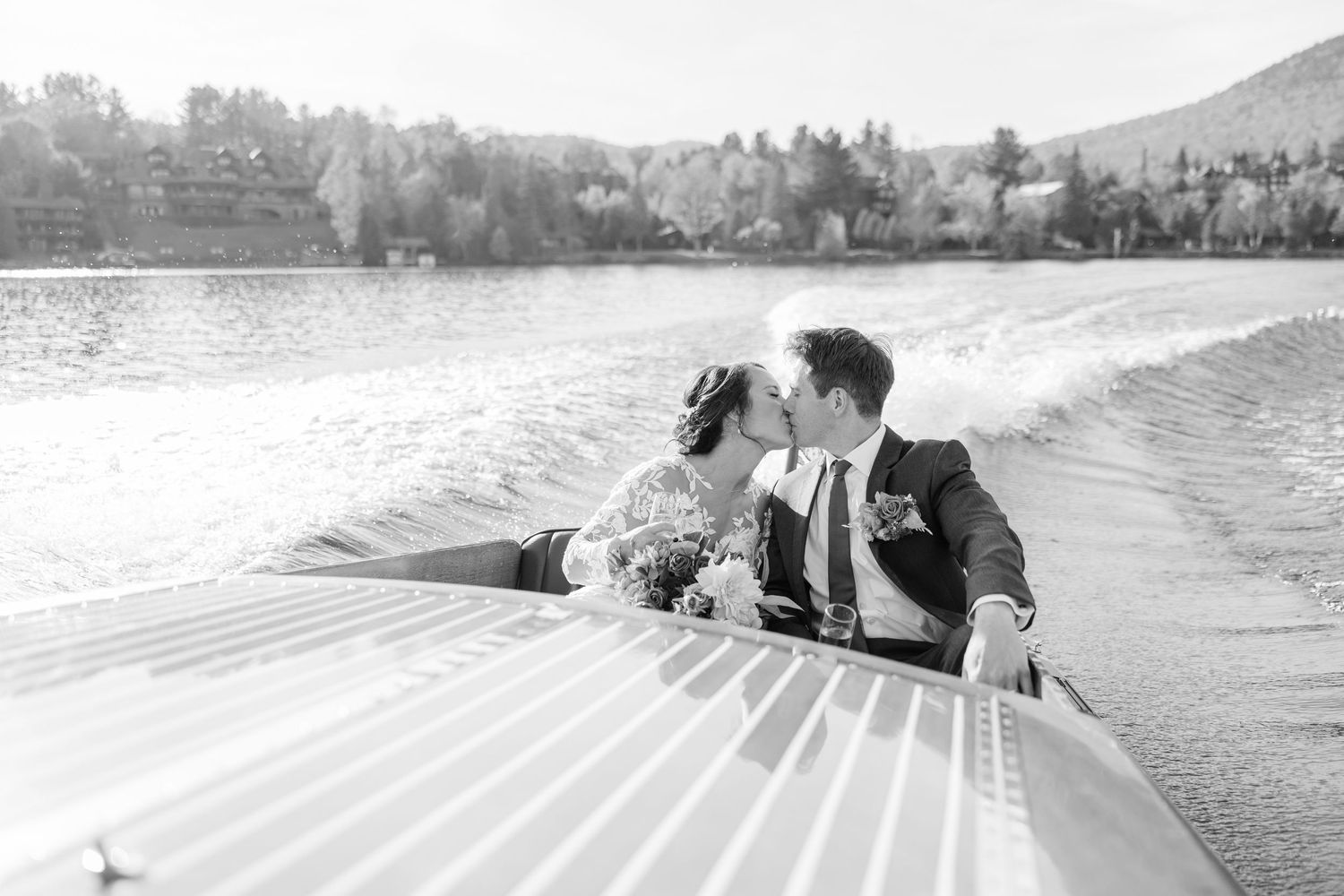 A bride and groom riding a Chris-Craft on Lake Placid in the Adirondack Mountains.