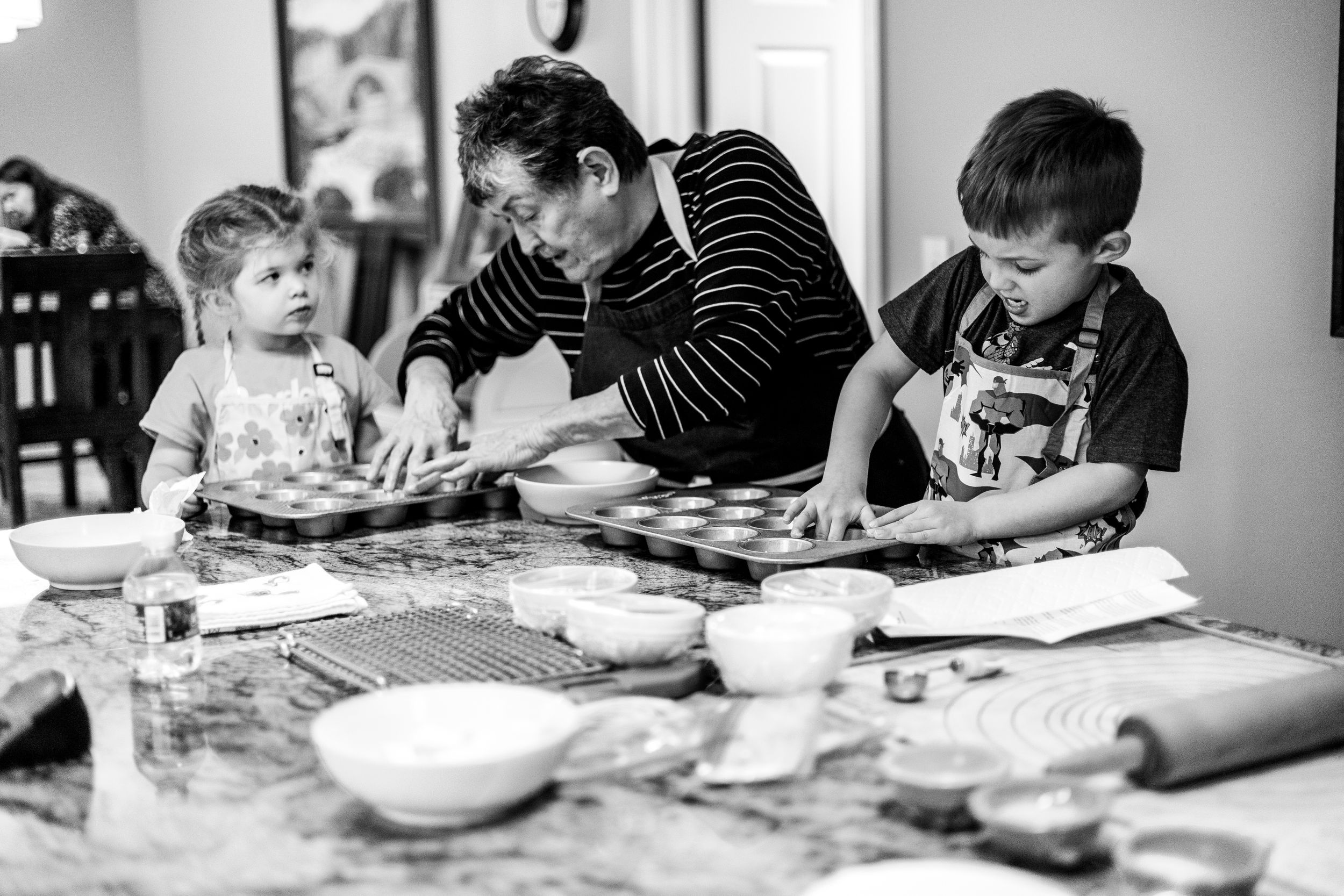 Black and white collage of photos showing various scenes of people at a table during a gathering or meal.