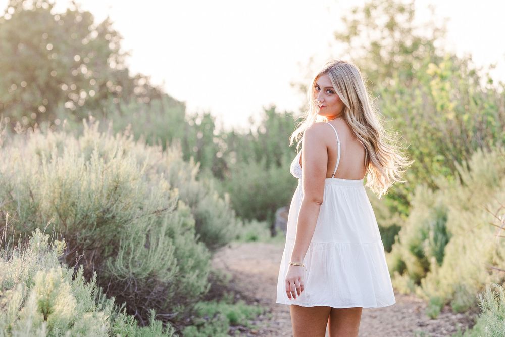 Ethereal outdoor portrait session in a desert garden with sage brush and natural elements.