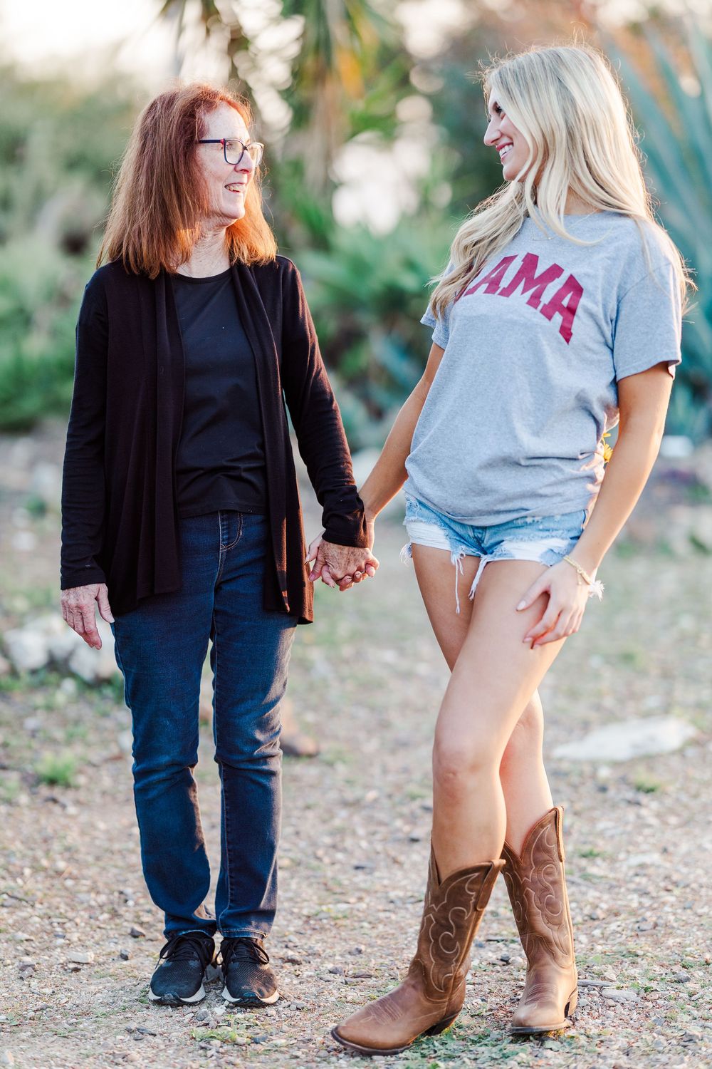 Two people sharing a candid moment while walking outdoors in casual attire.