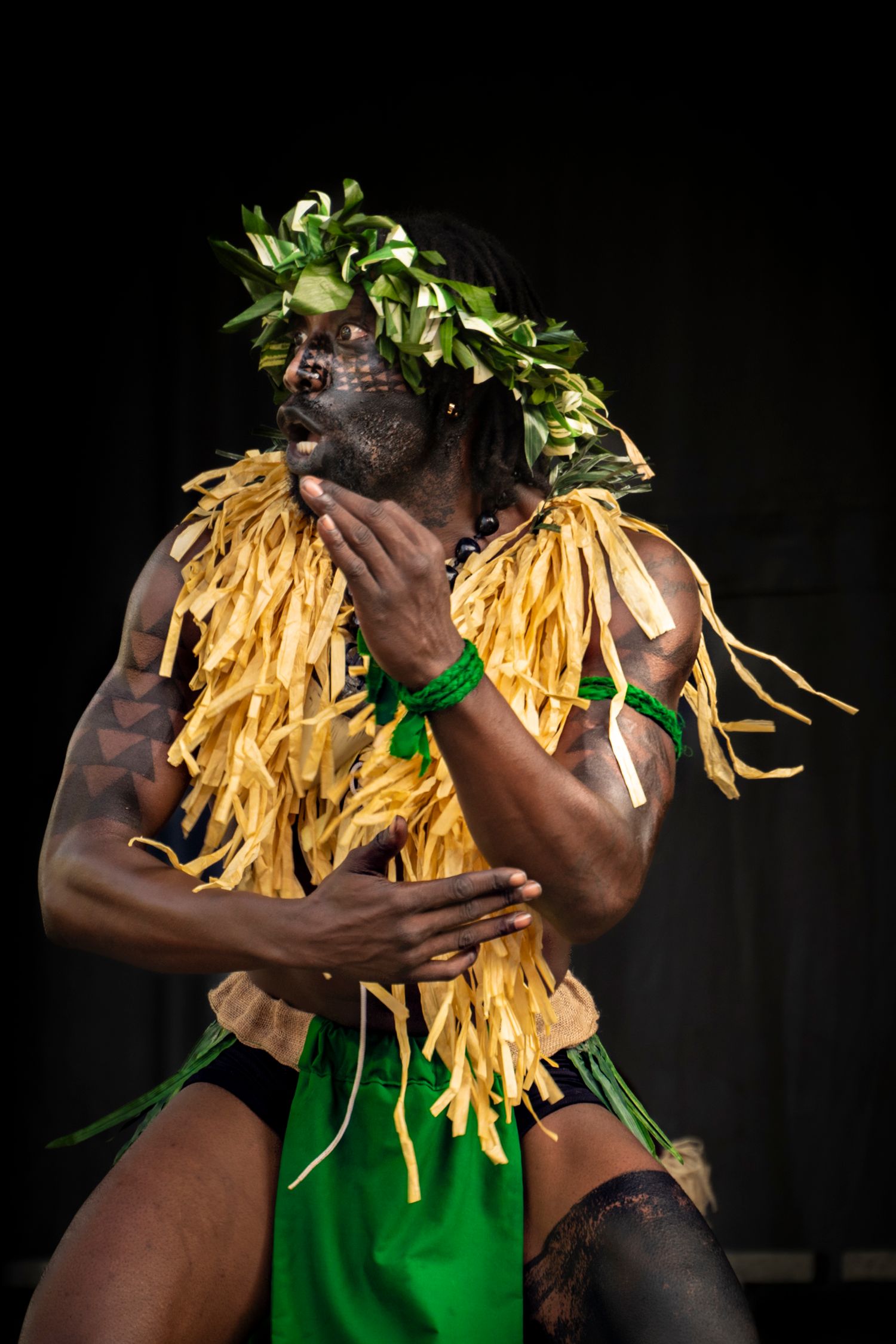 Artistic photo series showing dancer in green costume with yellow straw-like decorative elements against black background.