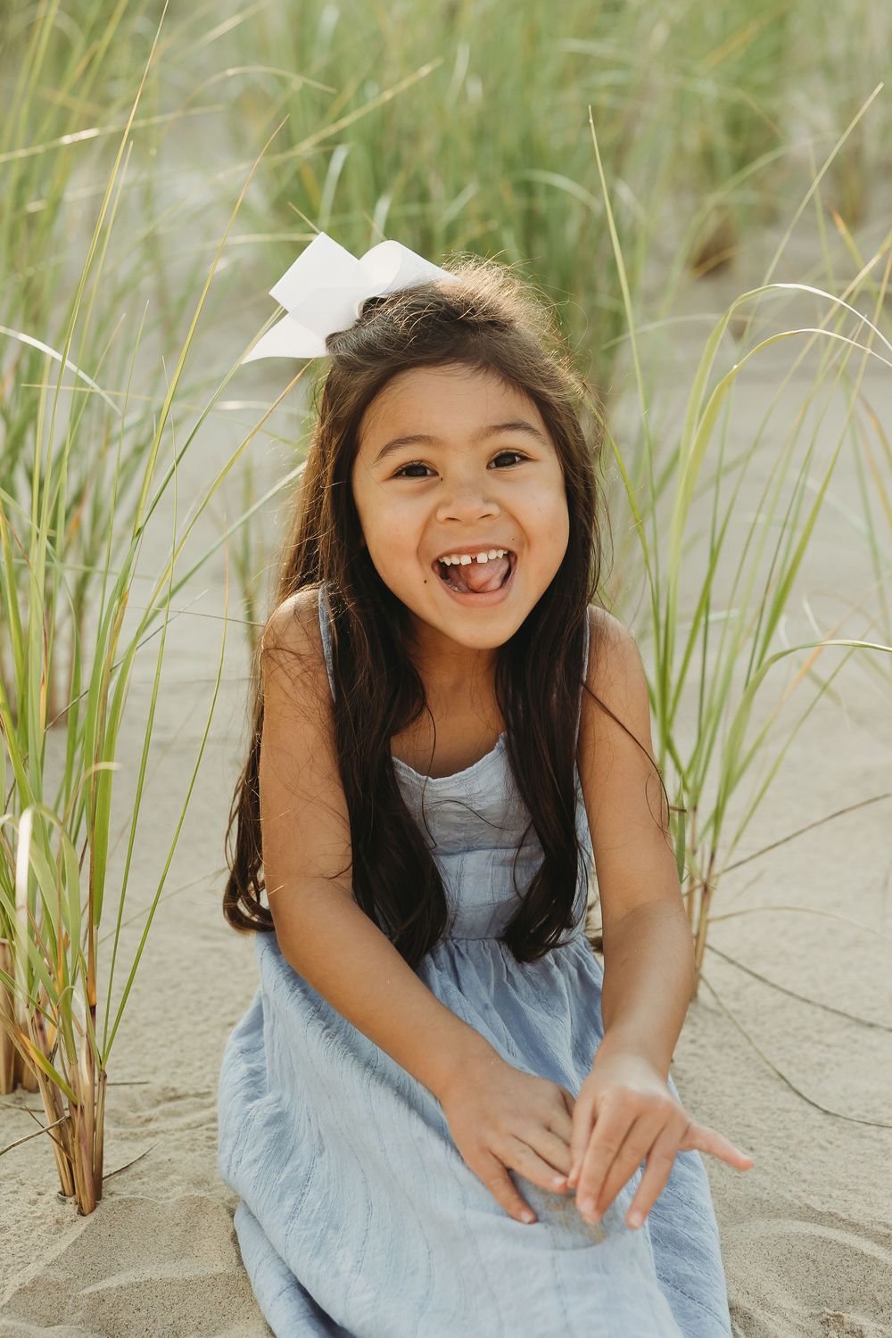 A series of candid beach portraits showing joyful expressions against sandy dunes with beach grass in soft lighting.