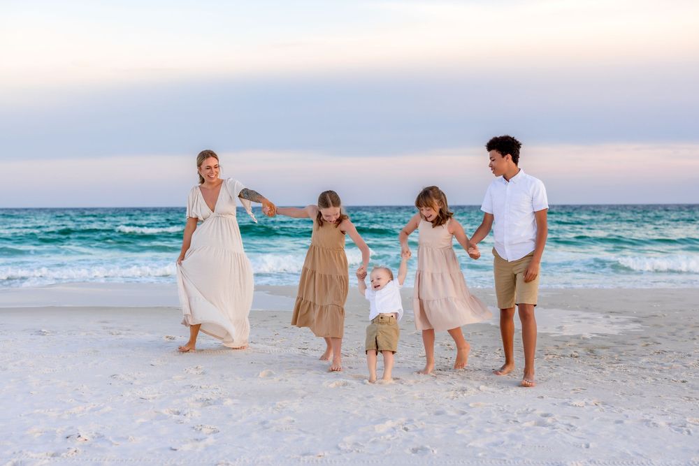 People enjoying a peaceful moment on the beach as waves roll in during golden hour.