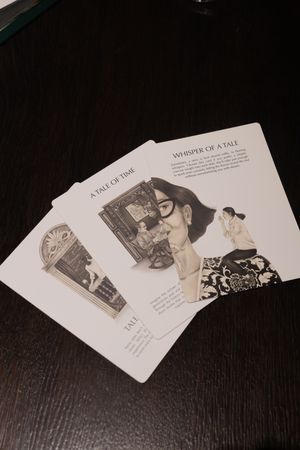 Story cards laid out on a dark wooden surface showing vintage illustrations and text.