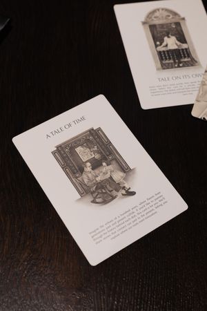 A storybook page with vintage illustrations and text laid out on a dark wooden surface.