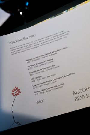 Wine menu pages with elegant typography and floral decorative elements on white paper.