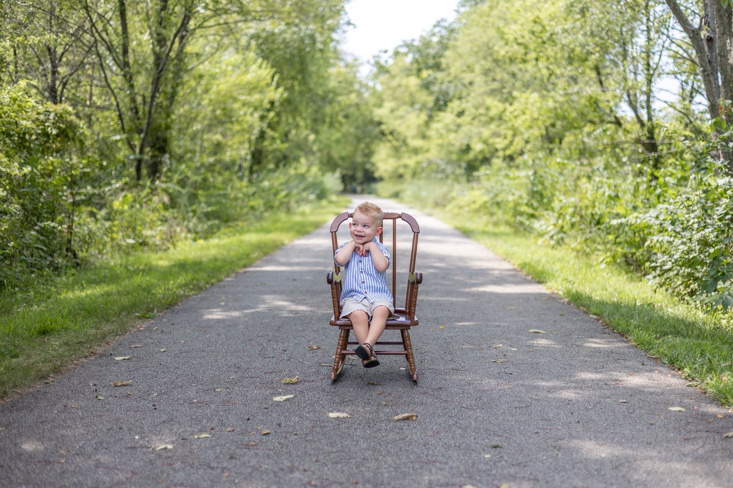 Springfield, IL Photographer captures a boy in a rocking chair on the Sangamon Valley Trail in Centennial Park, Springfield, IL
