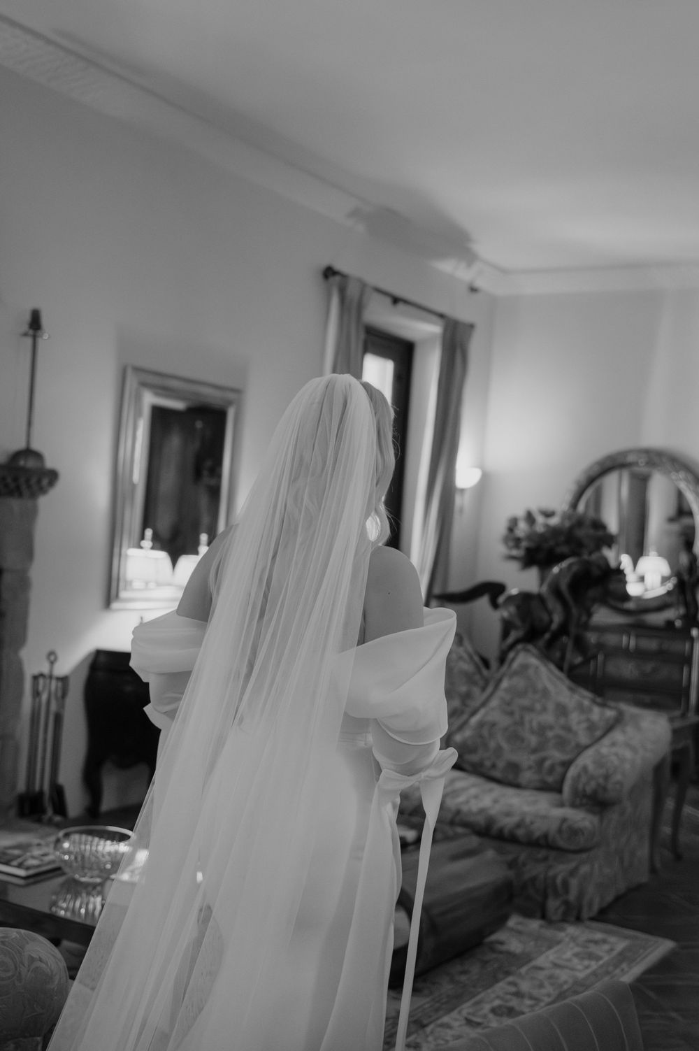 A series of black and white photos showing a dimly lit bedroom interior with vintage furniture and draped curtains.
