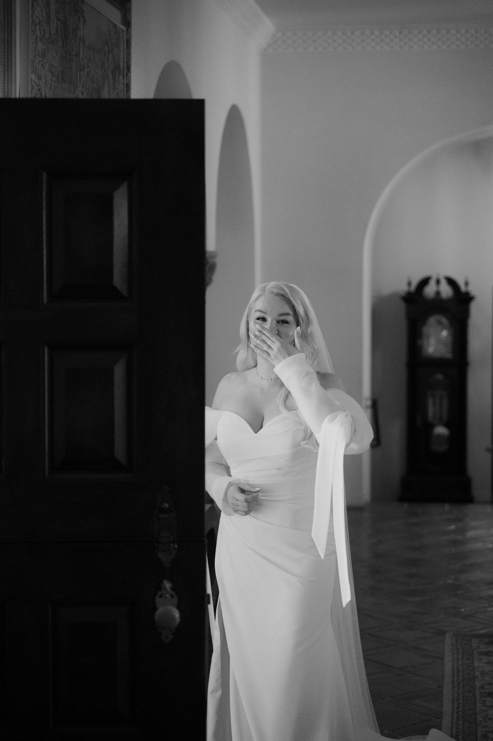 A sequence of black and white photos showing a white wedding dress in an empty church interior.