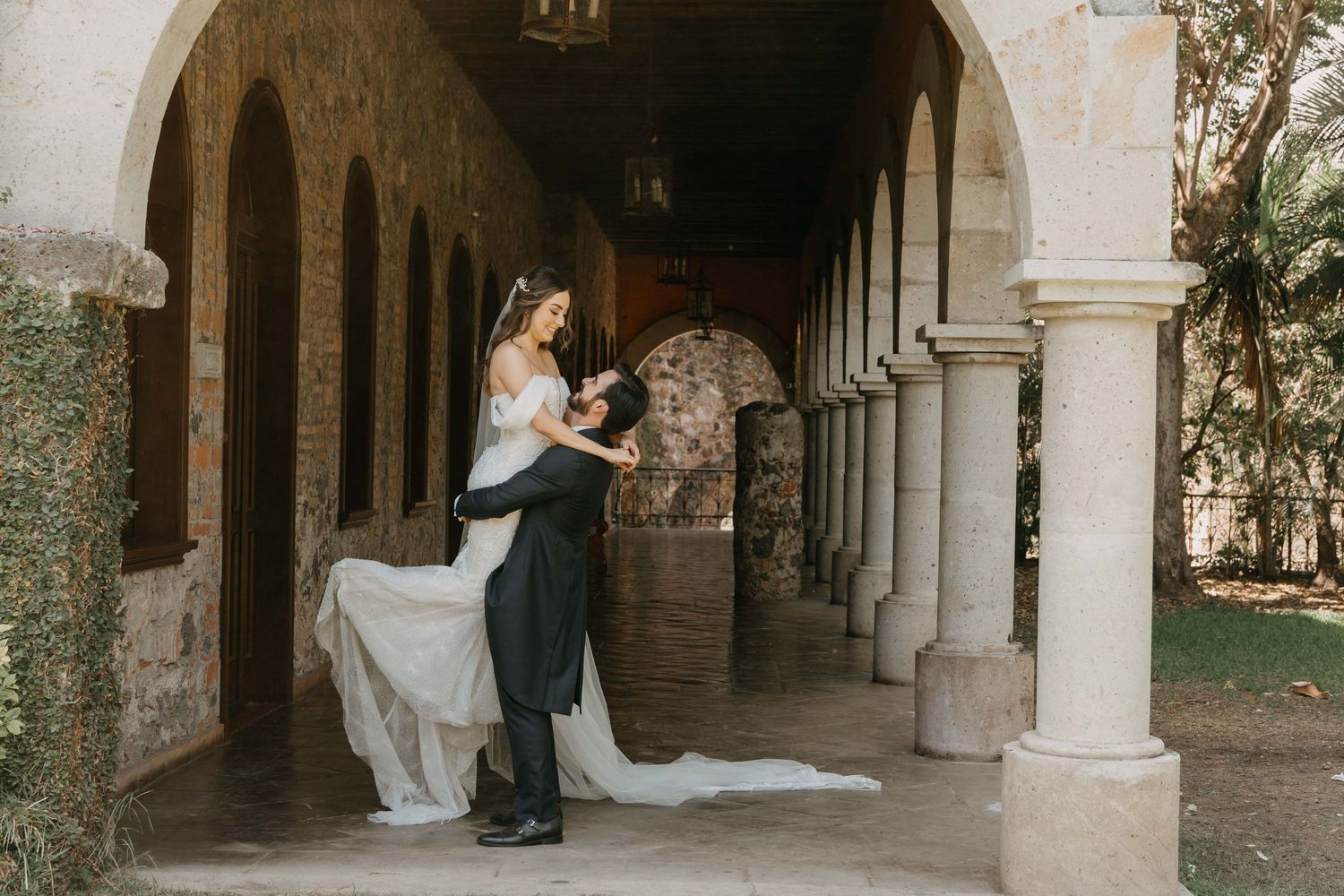 Romantic archways and stone columns create an elegant architectural backdrop.