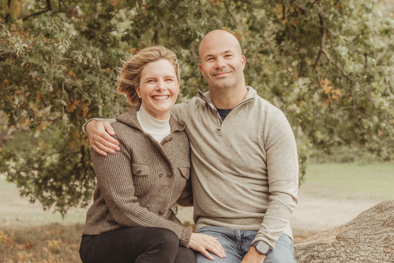 Family photo session in a natural outdoor setting with warm autumn colors.