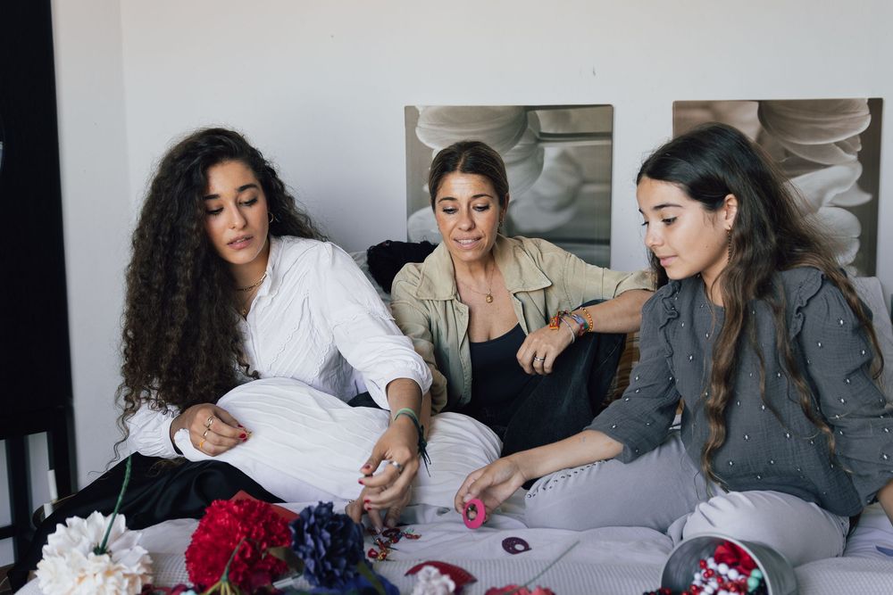 Candid lifestyle photos arranged in a collage showing casual moments on a sofa with flowers.