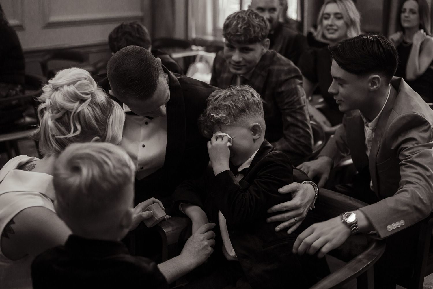 the bride and bestman comfort the bride's son as he is overcome with emotion watching his parents get married at old marylebone town hall