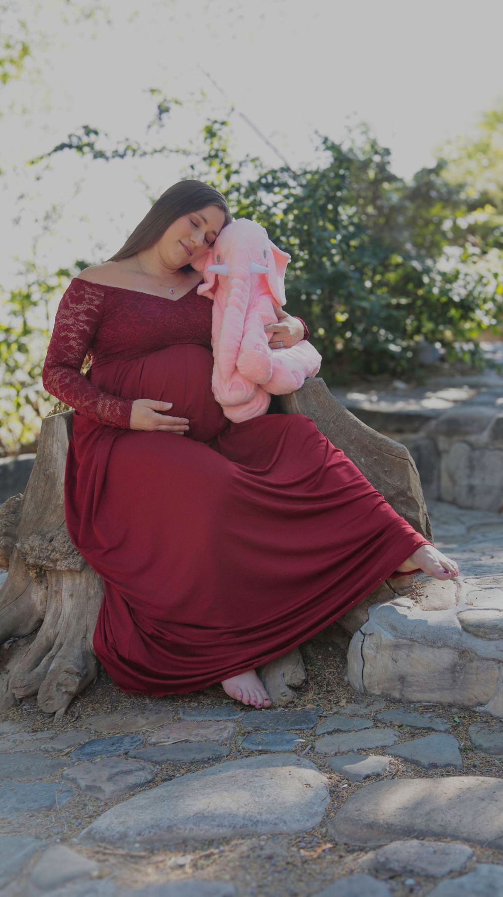 Mother holding an elephant plush as a symbol of infant loss during a quiet, emotional moment