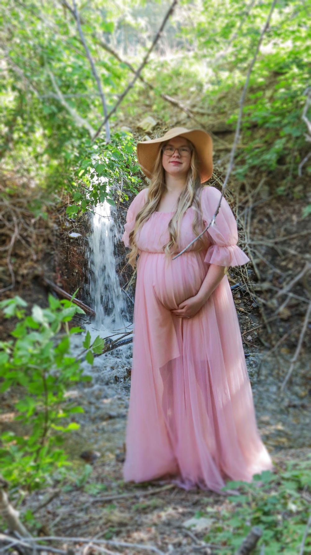 Expecting mother in a flowing dress during an outdoor maternity photography session
