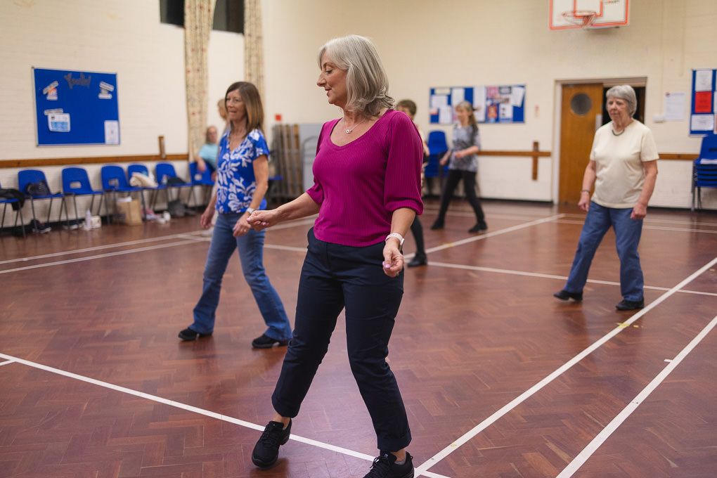 Group of people participating in a line dancing class in Hertfordshire.
