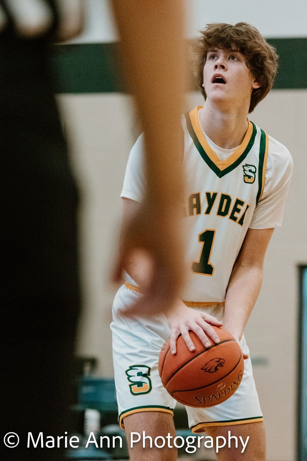 Saydel basketball player #1 focusing on the hoop while preparing to shoot a free throw.