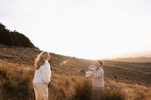 Sunset family/ maternity session at Port Hills. Dad holding son playing peek a boo with mum