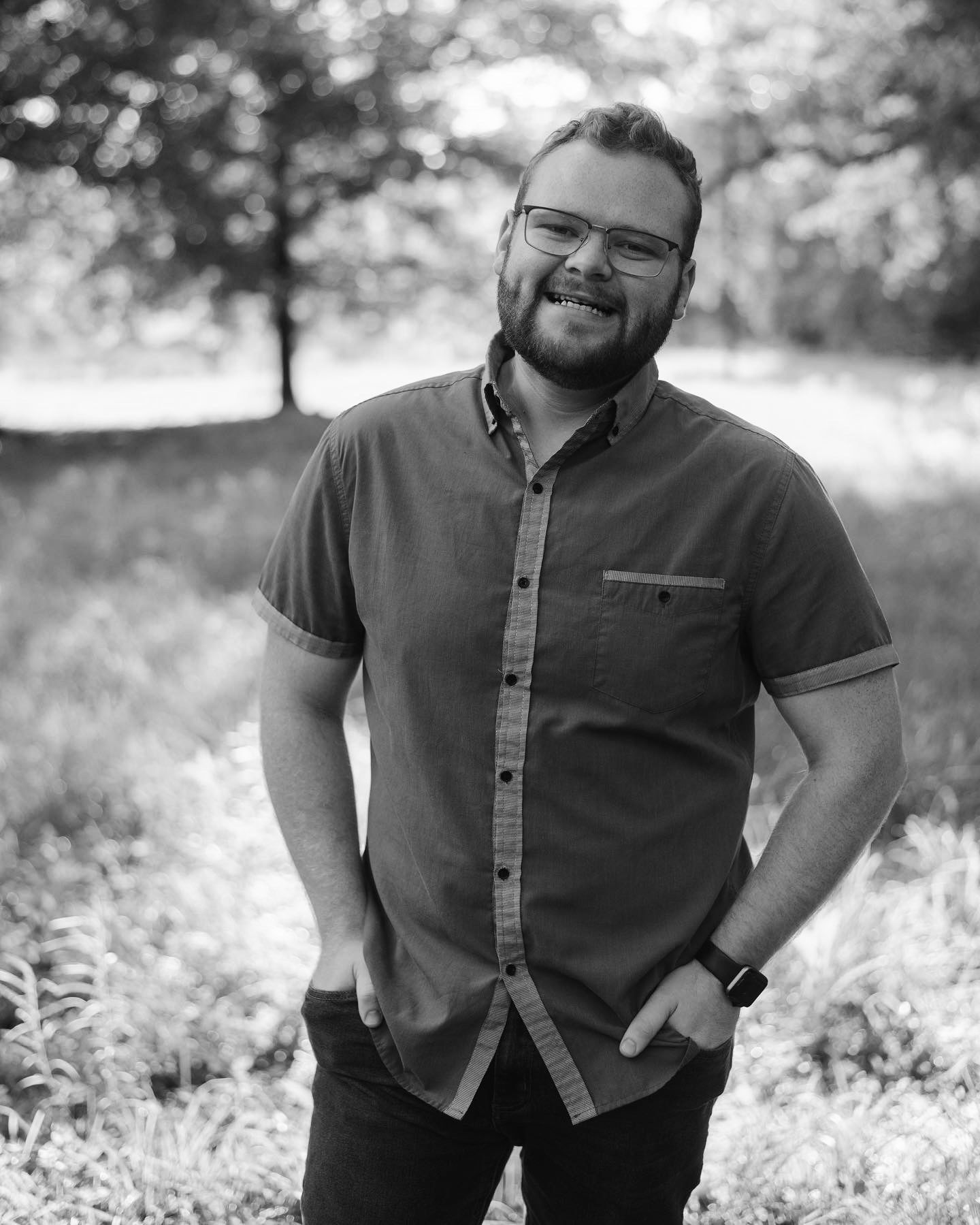 Black and white portrait in outdoor natural setting.
