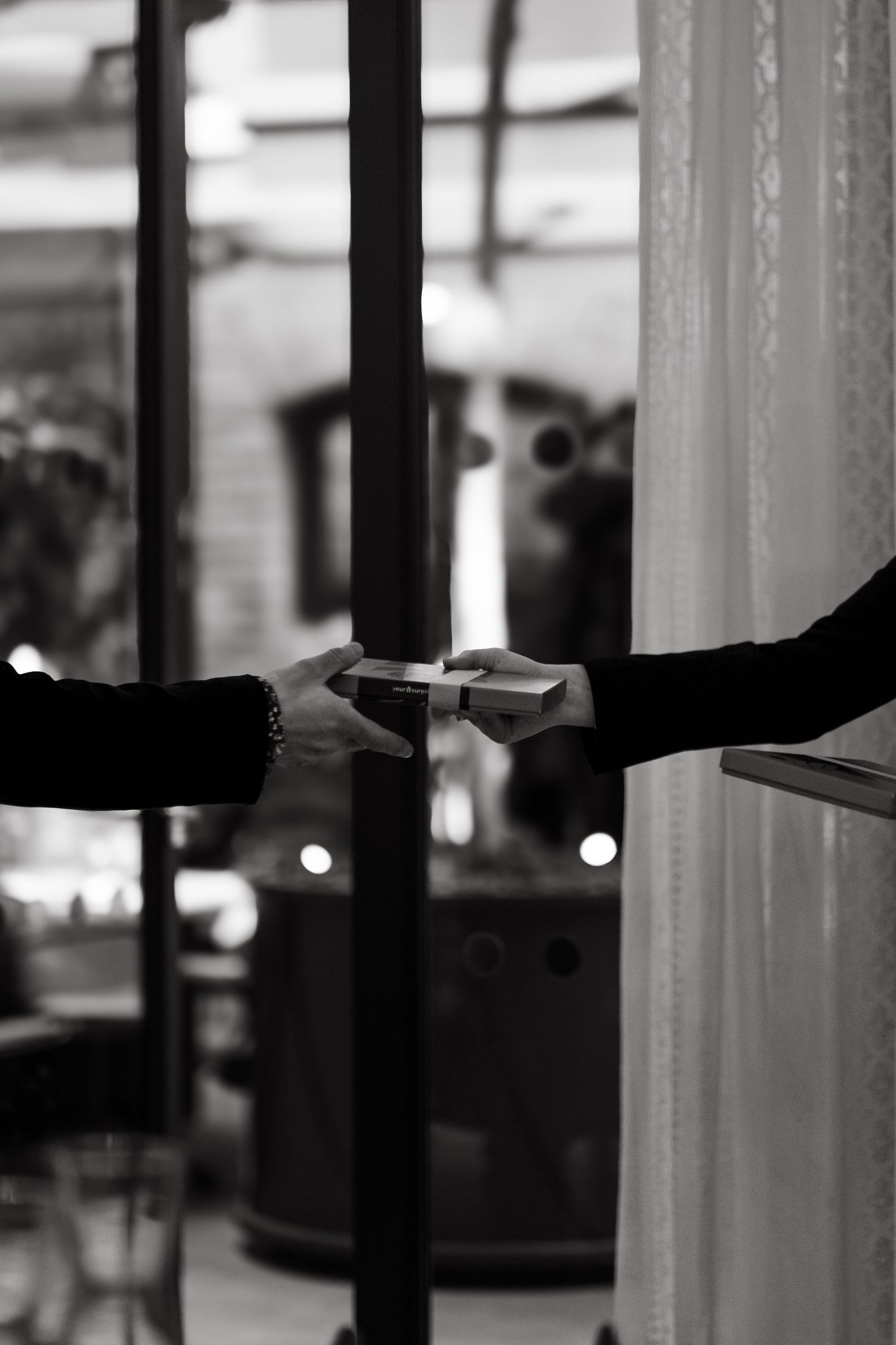 detail of two hands holding a box of chocolates captured by lifestyle event photographer in Stockholm