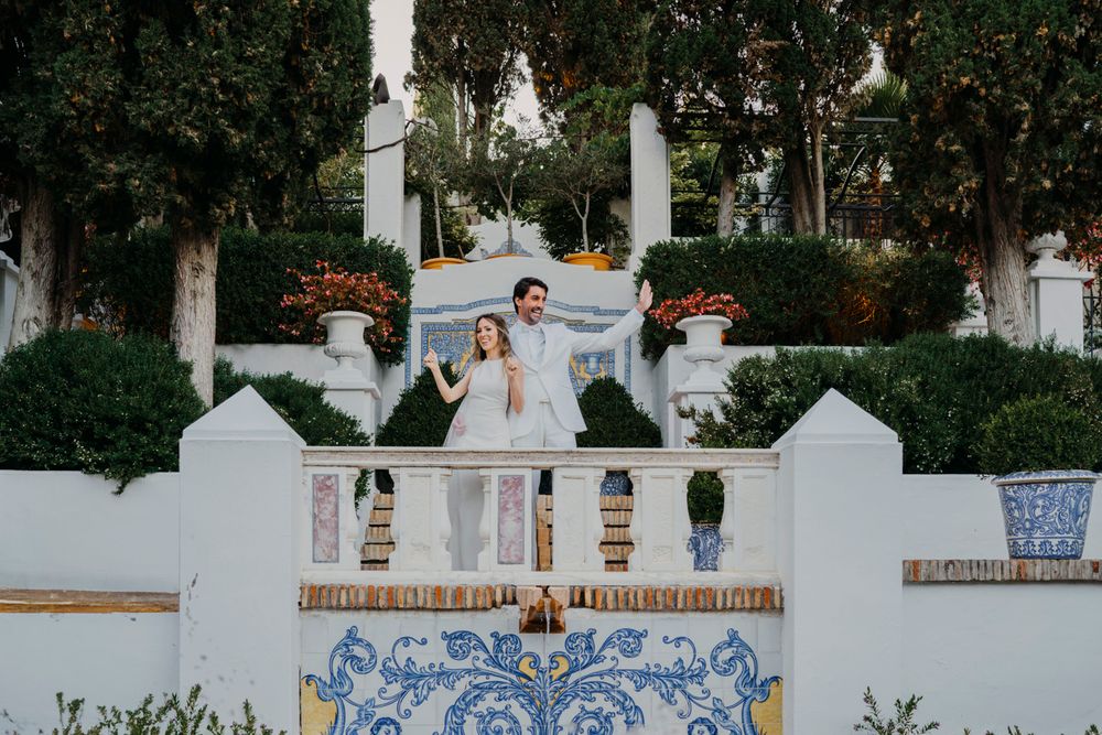 An outdoor staircase with white walls and blue Portuguese tiles at a garden wedding venue.
