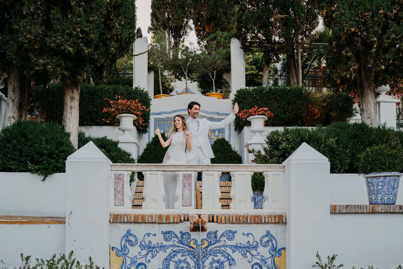 An outdoor staircase with white walls and blue Portuguese tiles at a garden wedding venue.