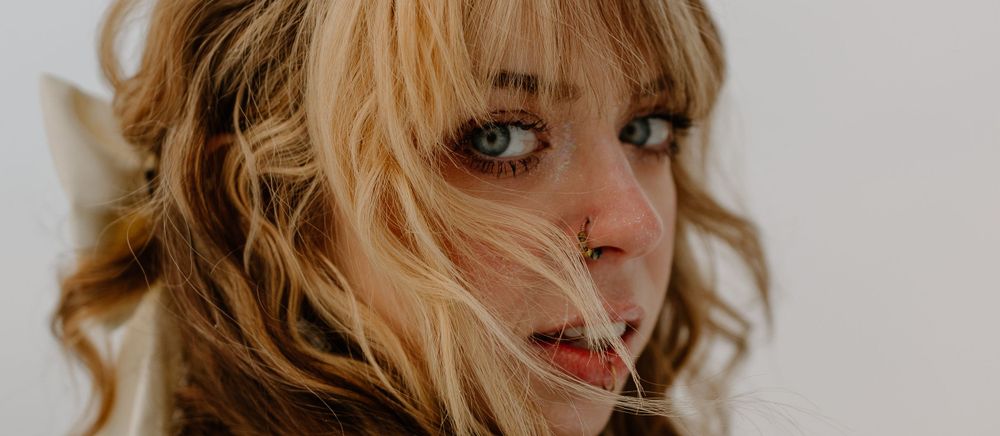 Close-up beauty portrait sequence showing eyes and hair in soft lighting.