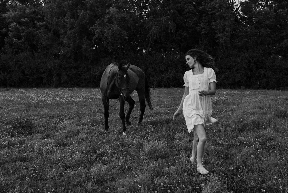 Black and white sequence showing a person walking with a horse in a grassy field.