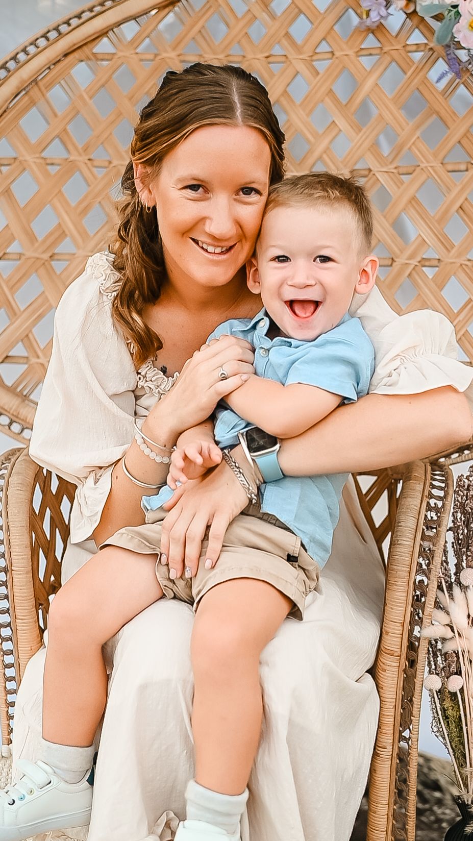 A heartwarming portrait of parent and child sharing a happy moment on a wicker chair.