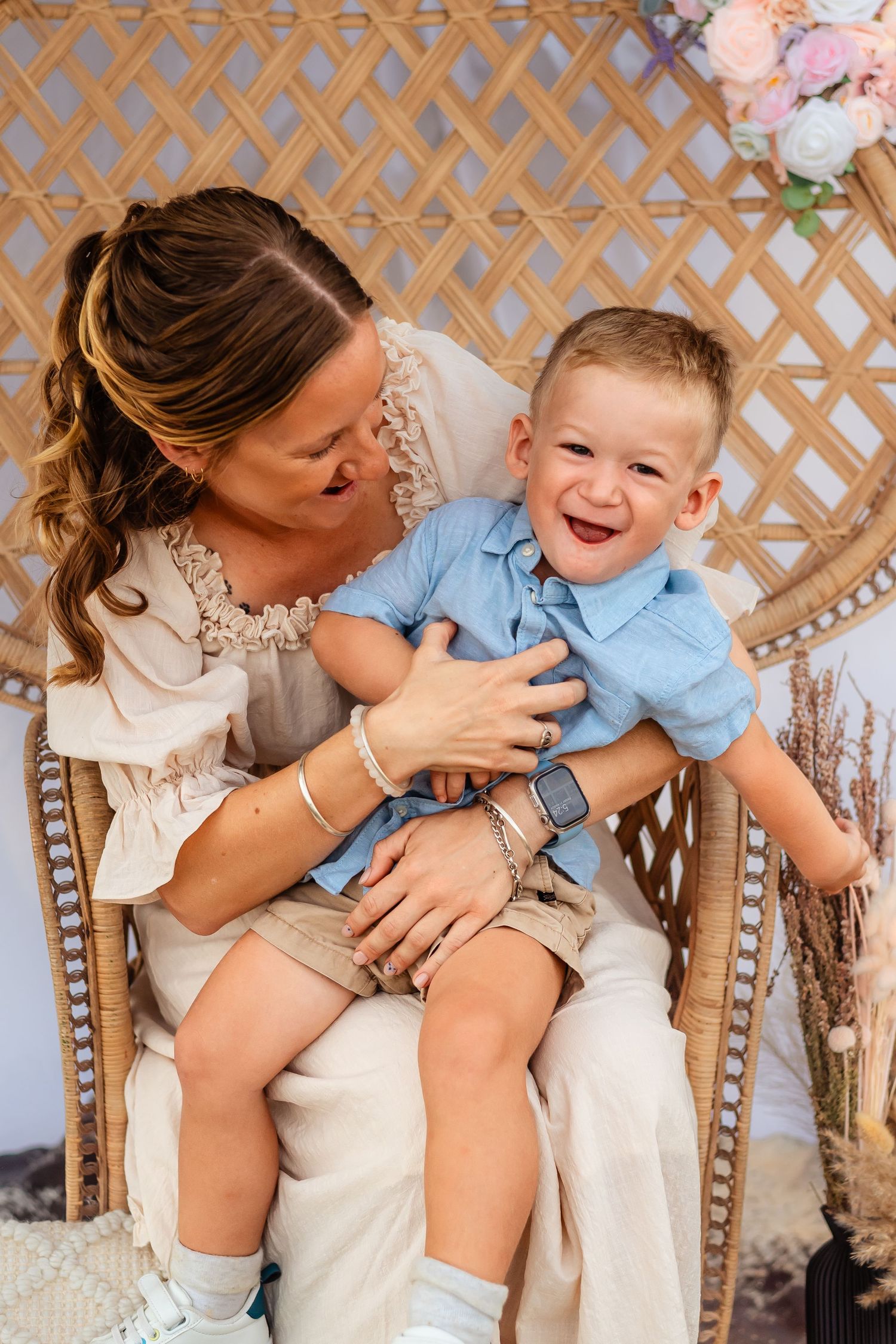 Playful moments between parent and child against a decorative outdoor lattice backdrop.