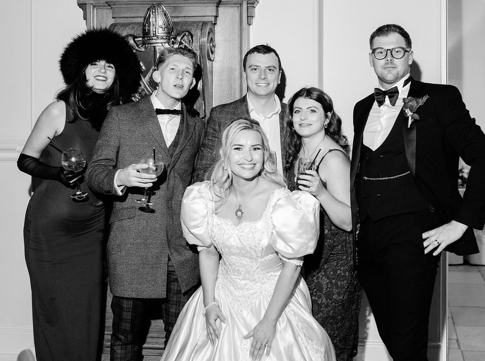 A black and white photo collage shows people dancing and celebrating at what appears to be a formal event.