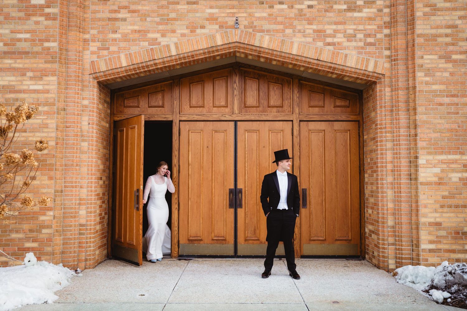 A sequence of four photos showing a wooden garage door opening progressively wider against a red brick wall.