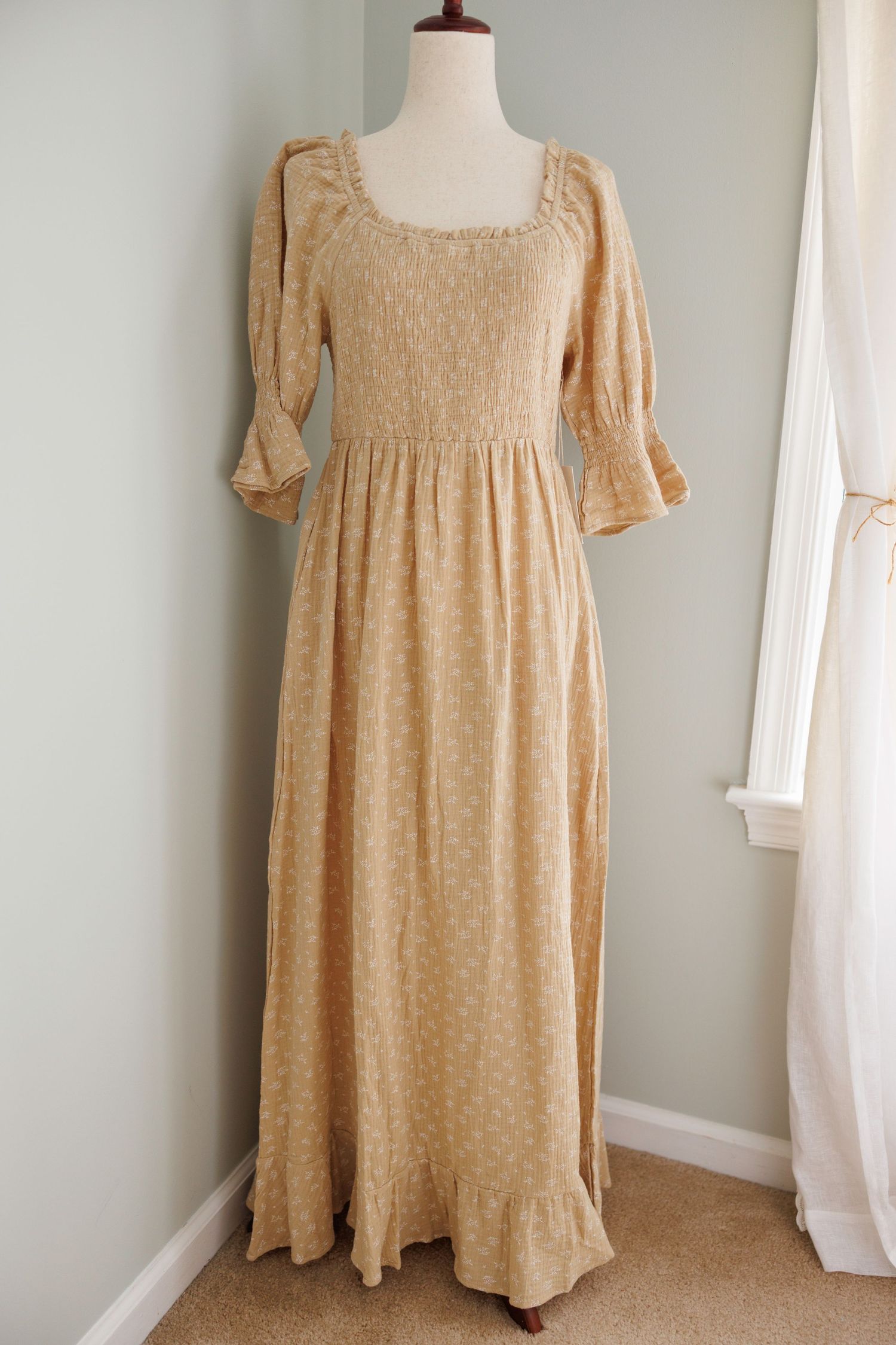 Vintage cream-colored peasant dress with puff sleeves and corset back lacing displayed on mannequin from multiple angles.