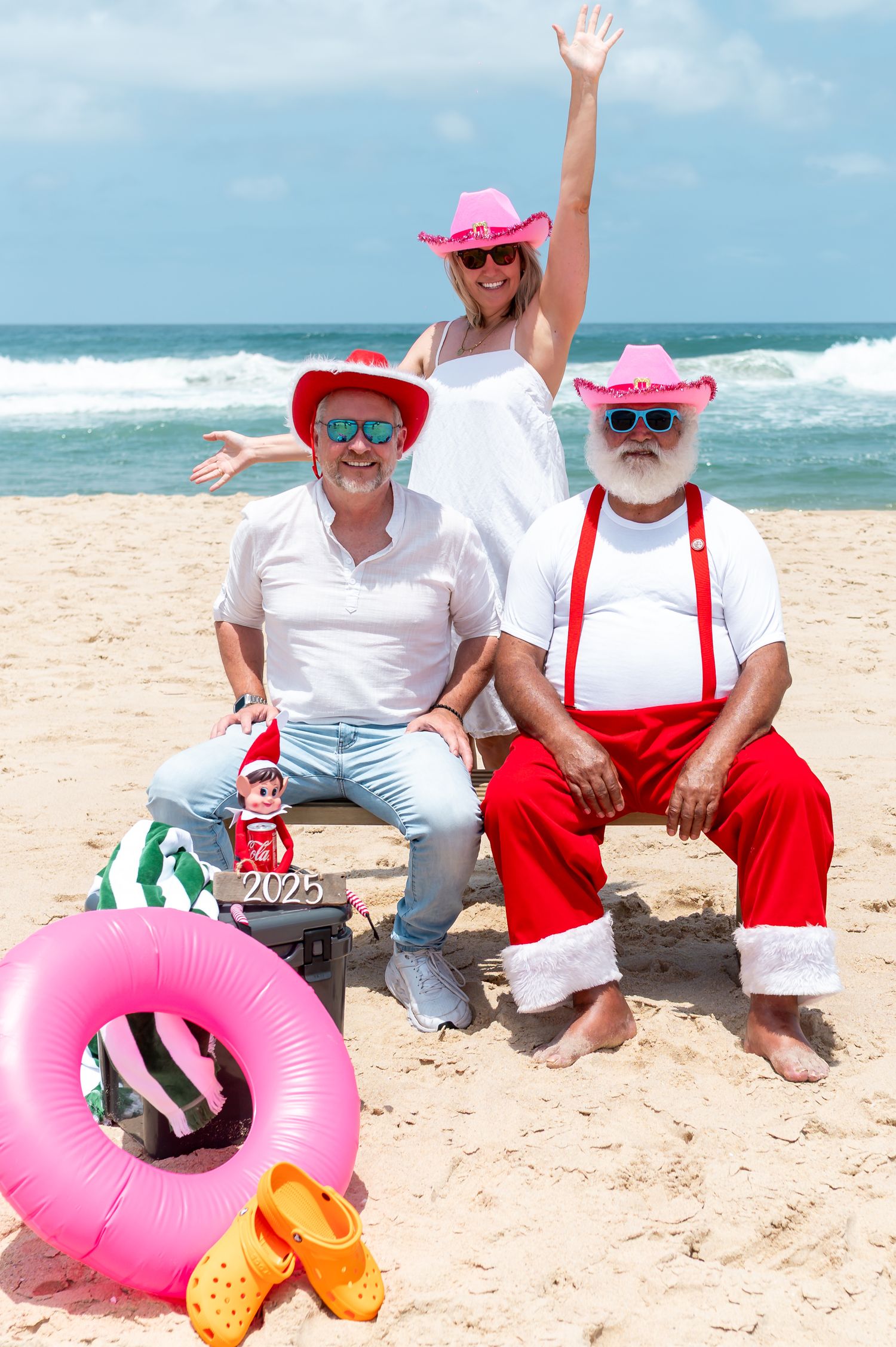 Coastal Christmas decorations and festive beach decor displayed along a sandy shoreline with ocean views.