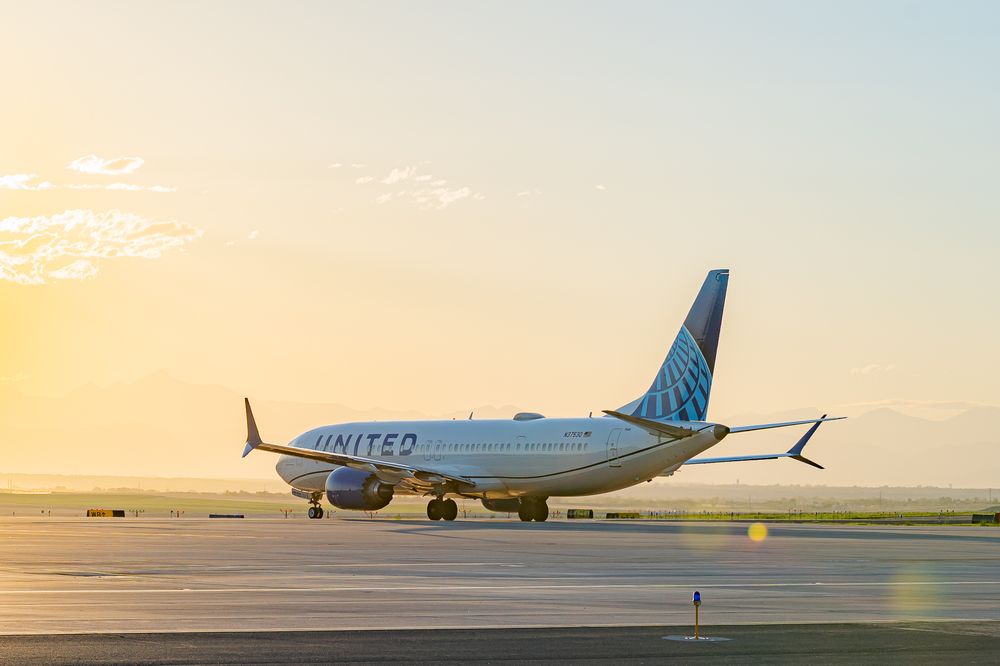 United Airlines planes parked on tarmac during golden sunset hours.
