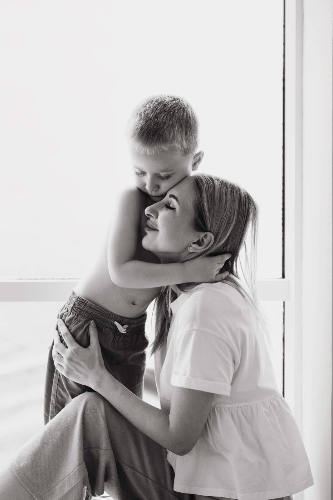 Mother son window light in home photoshoot
