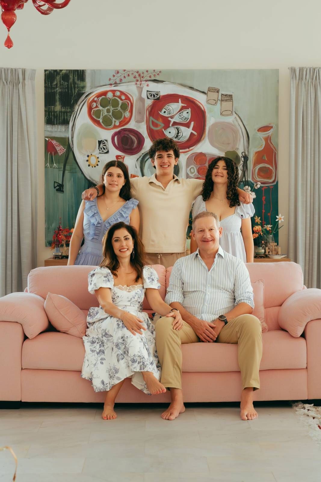 Family gathering with multiple generations in white outfits indoors