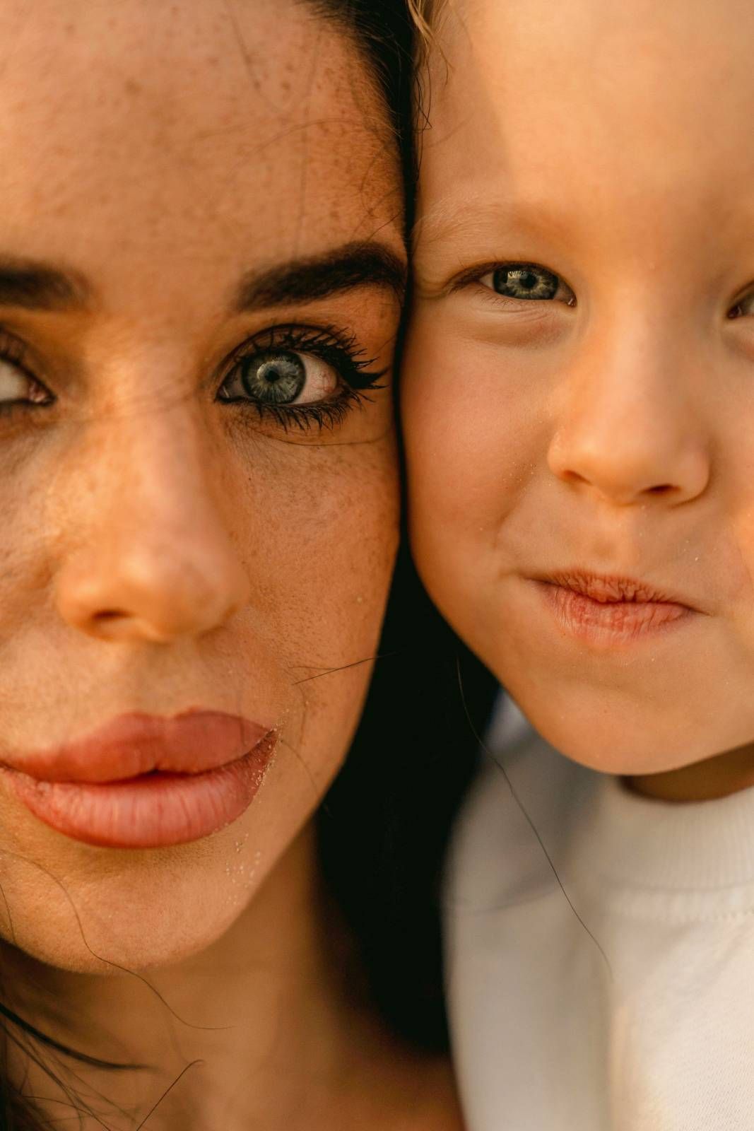 Close up portrait of two young girls with heads together smiling