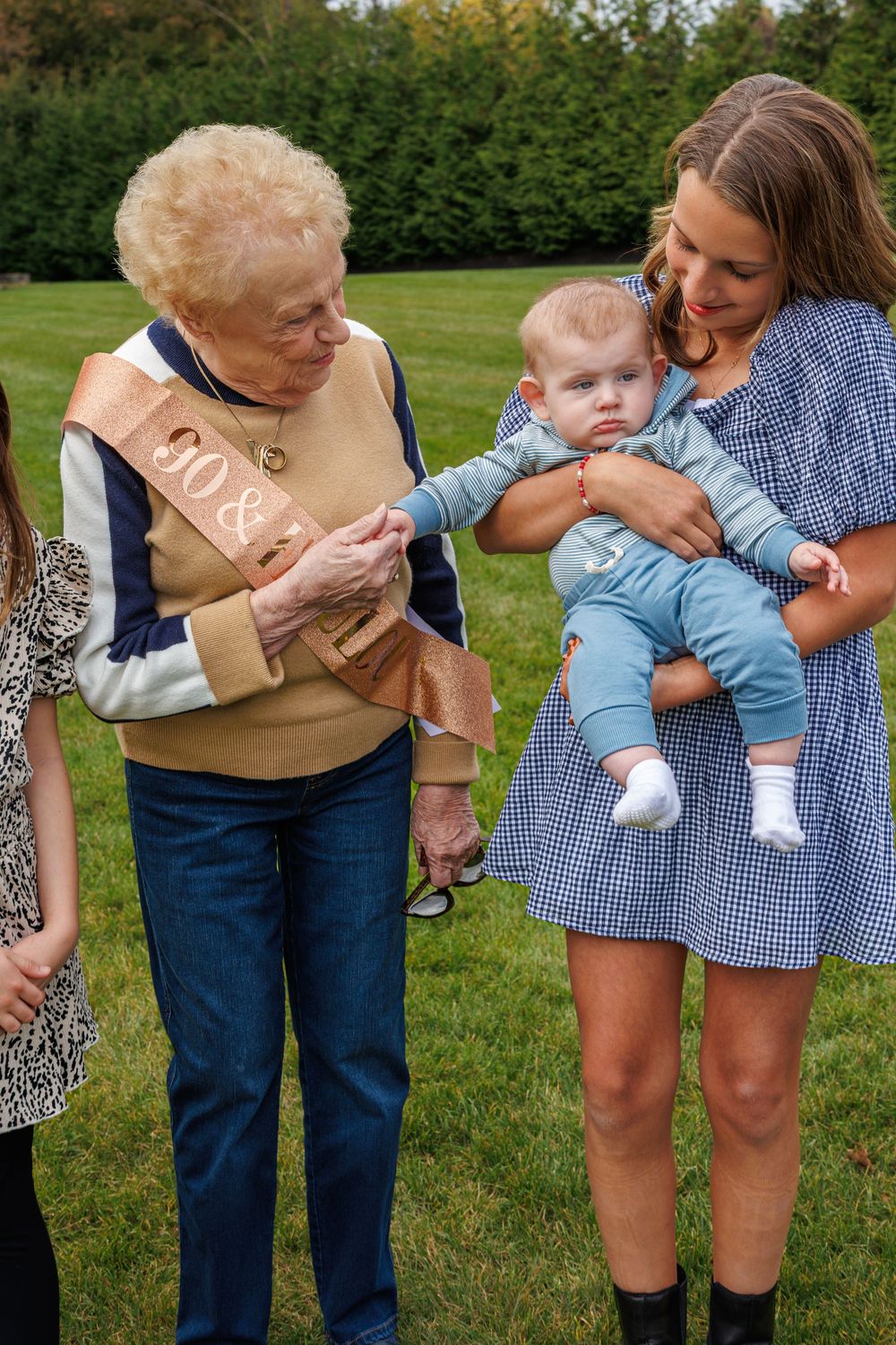 Tender family moments captured in a series of outdoor photos on green grass.