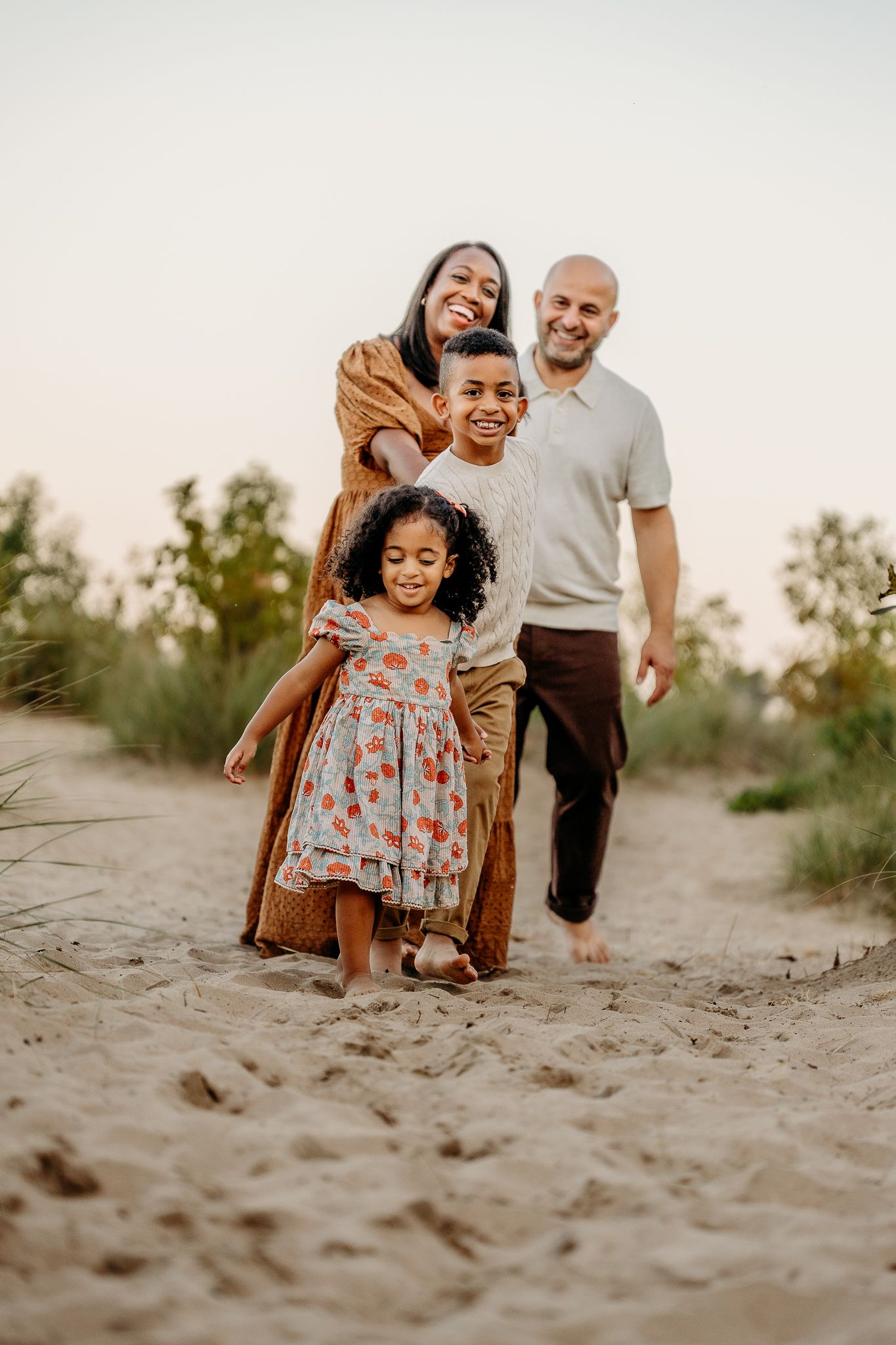 Family walking along the shoreline during a North Shore Chicago beach photo session