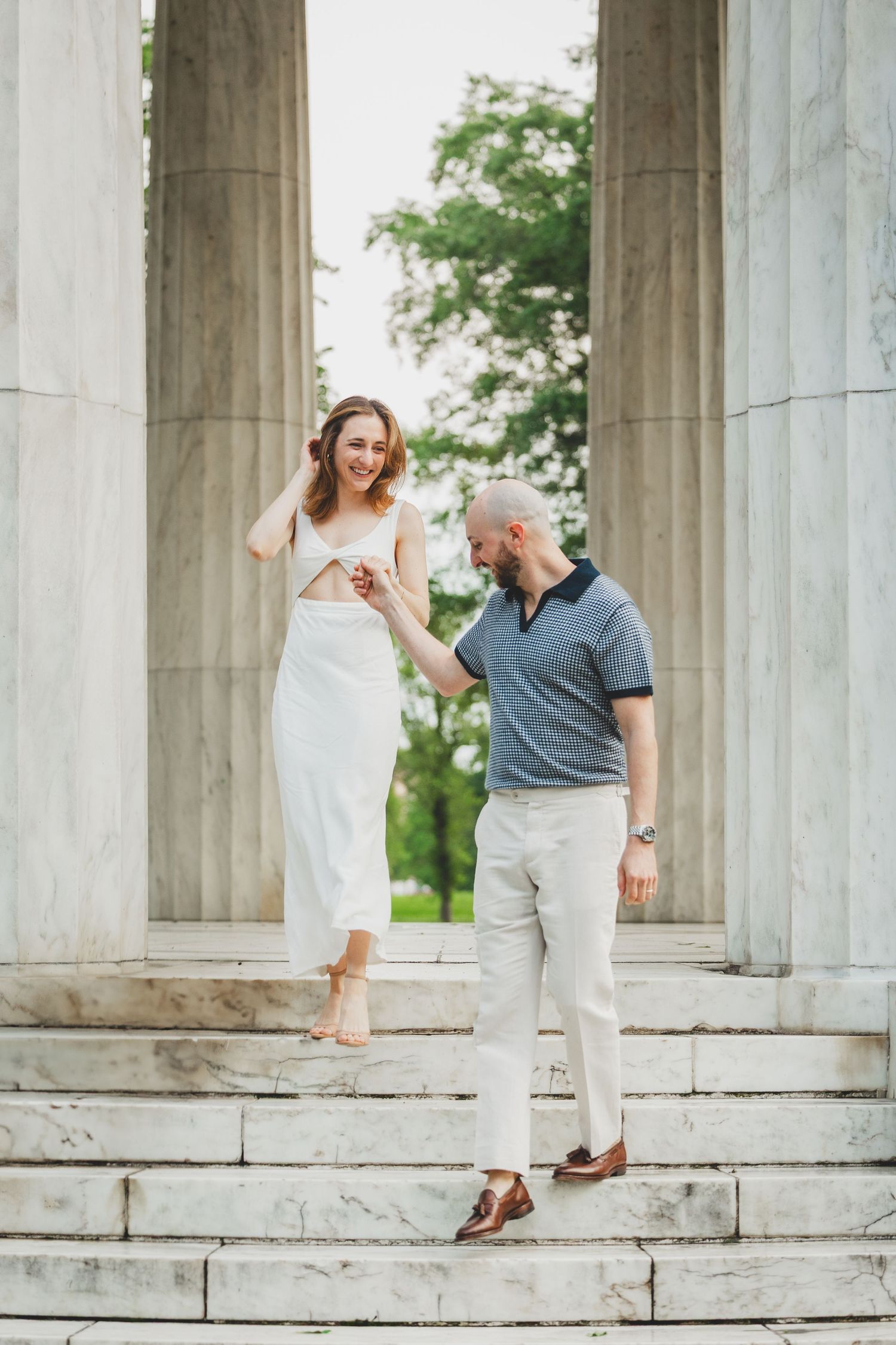 Close up of the couple standing face to face and holding hands at the memorial