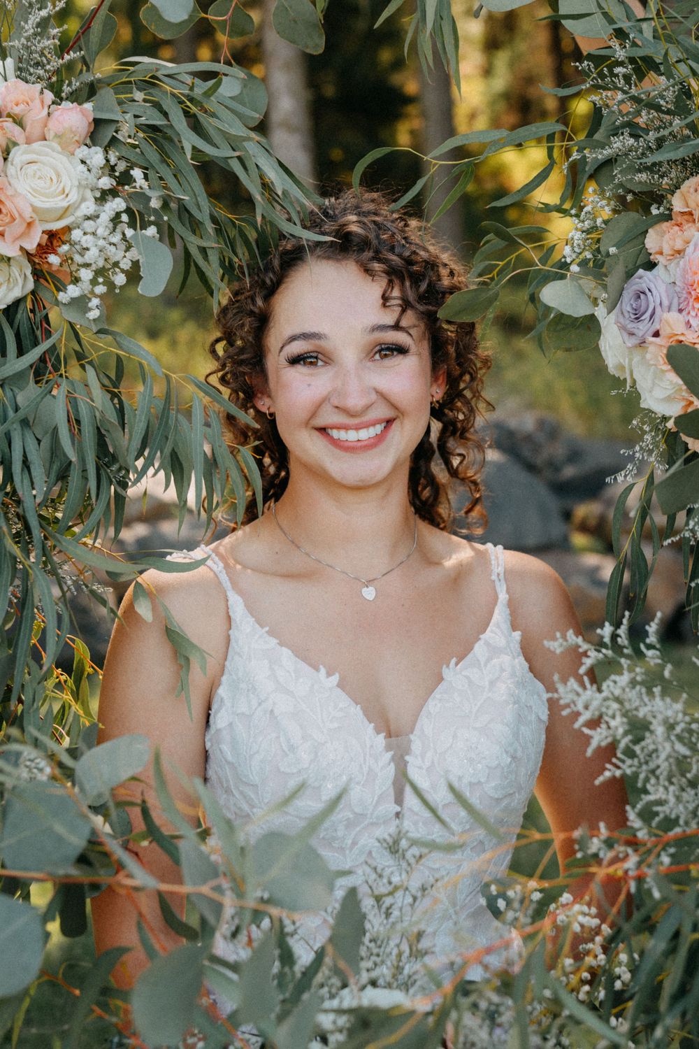 Ethereal bridal portraits framed by lush greenery and delicate floral arrangements in a garden setting.