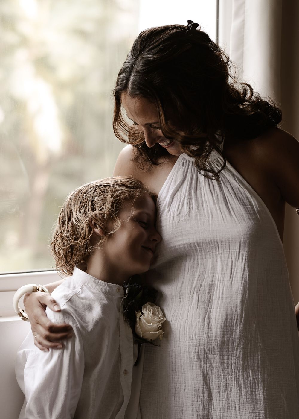 A tender moment captured in a series of intimate black and white photographs showing gentle embraces.