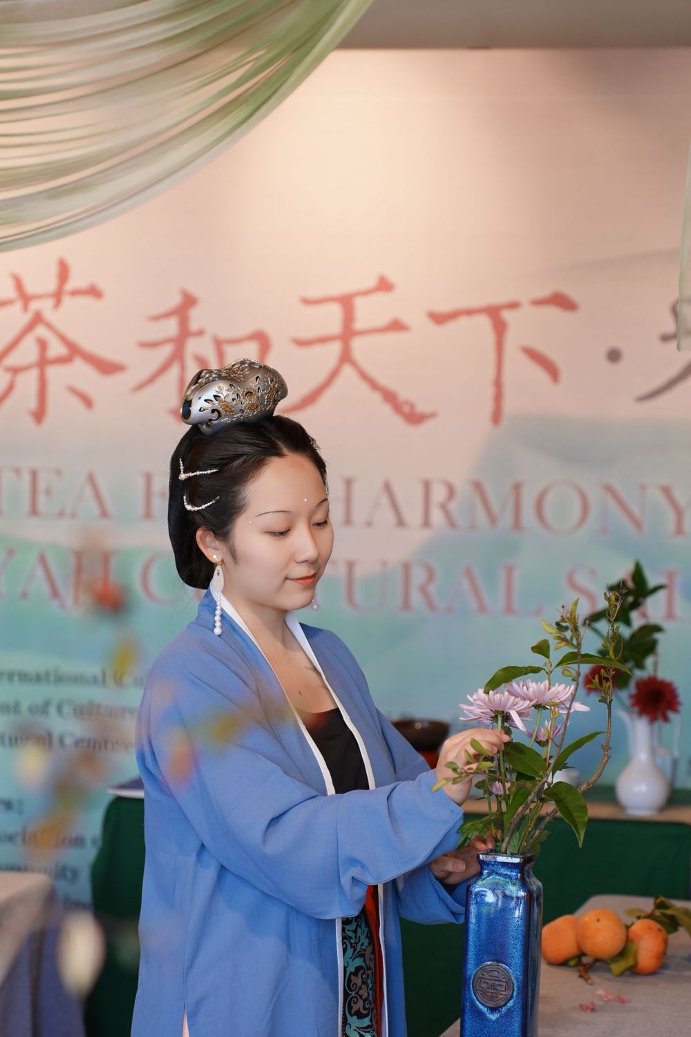 Event photography of diverse guests enjoying a traditional Chinese tea culture experience in Hanfu, by an Auckland photographer.