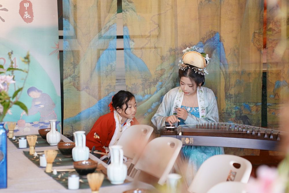 Event photography of diverse guests enjoying a traditional Chinese tea culture experience in Hanfu, by an Auckland photographer.