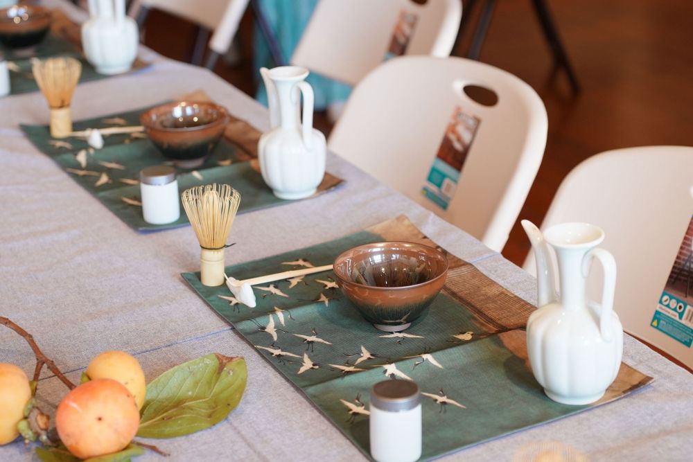 Event photography of diverse guests enjoying a traditional Chinese tea culture experience in Hanfu, by an Auckland photographer.