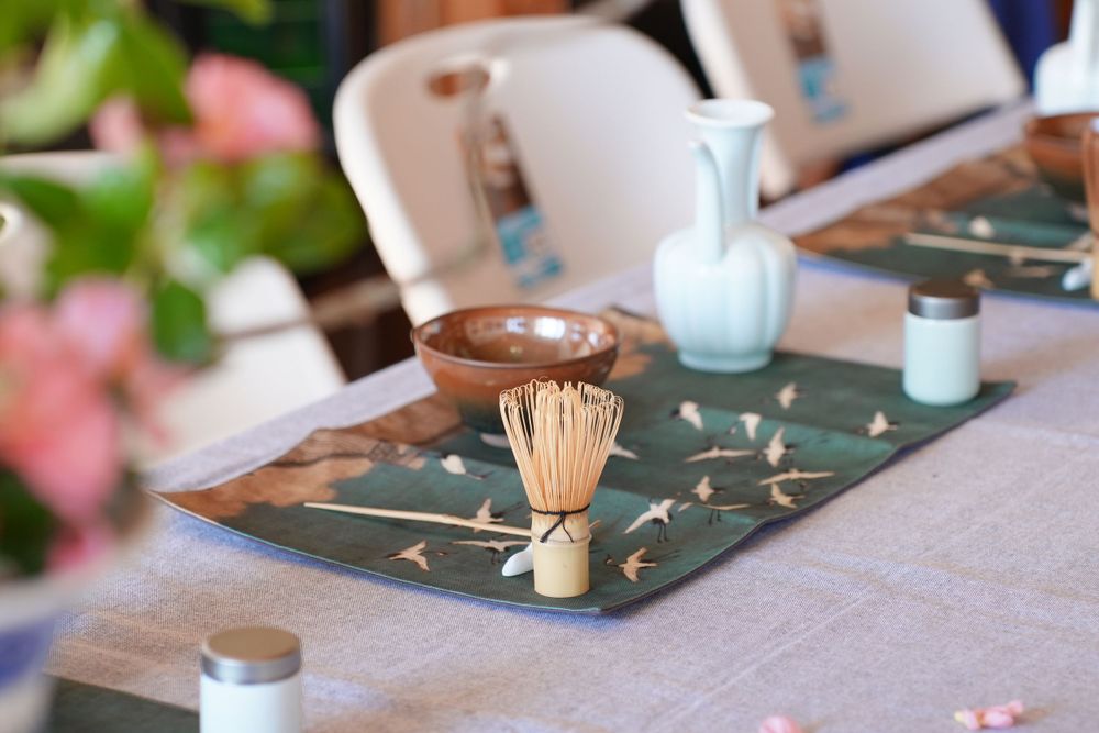 Event photography of diverse guests enjoying a traditional Chinese tea culture experience in Hanfu, by an Auckland photographer.